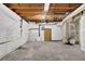 Unfinished basement with concrete flooring, exposed ceiling, door, and utility connections at 361 Gordon Valley Sw Ln, Mableton, GA 30126