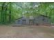 Exterior side view of the home features a deck and a wooded backyard at 361 Gordon Valley Sw Ln, Mableton, GA 30126