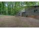 Side view of the exterior home featuring a chimney, deck, and spacious backyard at 361 Gordon Valley Sw Ln, Mableton, GA 30126