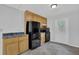 Functional kitchen featuring wood cabinets, black appliances, and tiled floors at 361 Gordon Valley Sw Ln, Mableton, GA 30126