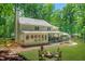 Lush backyard featuring a fire pit, covered patio, and fenced-in area at 3870 Windhurst Dr, Lilburn, GA 30047
