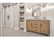 Bathroom with vanity and storage featuring sliding barn door and tile flooring at 3870 Windhurst Dr, Lilburn, GA 30047