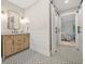 Hallway bath featuring decorative tile and barn door access to the bed room at 3870 Windhurst Dr, Lilburn, GA 30047
