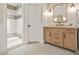Modern bathroom featuring a tiled shower, stylish vanity, and patterned flooring at 3870 Windhurst Dr, Lilburn, GA 30047