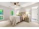 Bright bedroom with a ceiling fan, side table and ensuite bathroom at 3870 Windhurst Dr, Lilburn, GA 30047