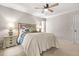 Bright bedroom features a ceiling fan, side table and windows with exterior views at 3870 Windhurst Dr, Lilburn, GA 30047