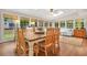 Well-lit dining room features hardwood floors, natural light, and a view to the backyard at 3870 Windhurst Dr, Lilburn, GA 30047