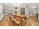 Spacious dining room with a large wooden table, hardwood floors, and chandelier at 3870 Windhurst Dr, Lilburn, GA 30047