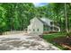 Traditional home featuring a spacious driveway, lush greenery, and a well-maintained lawn at 3870 Windhurst Dr, Lilburn, GA 30047