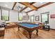 Spacious game room featuring a pool table, comfortable leather seating, and rustic wood beams at 3870 Windhurst Dr, Lilburn, GA 30047
