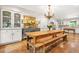 Bright kitchen with modern appliances and a chandelier over a large wooden dining table at 3870 Windhurst Dr, Lilburn, GA 30047