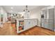 Kitchen island with breakfast bar, cabinetry, and stainless steel refrigerator at 3870 Windhurst Dr, Lilburn, GA 30047