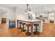 Kitchen with an island that offers seating, hardwood floors, and stainless steel appliances at 3870 Windhurst Dr, Lilburn, GA 30047