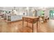 Open kitchen area with a central island, white cabinets, stainless steel appliances, and wooden floor at 3870 Windhurst Dr, Lilburn, GA 30047