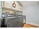 Convenient laundry area with modern washer/dryer units, ample cabinetry, and stylish floral wallpaper at 3870 Windhurst Dr, Lilburn, GA 30047