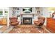Bright living room showcases a fireplace, built-in shelving, and hardwood floors with an eye-catching area rug at 3870 Windhurst Dr, Lilburn, GA 30047