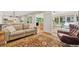 Spacious open concept living area with hardwood floors, neutral sofa, and leather chair at 3870 Windhurst Dr, Lilburn, GA 30047