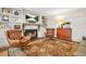 Inviting living room features a cozy fireplace, built-in shelves, hardwood floors, and comfortable leather chairs at 3870 Windhurst Dr, Lilburn, GA 30047