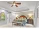 Large main bedroom with sitting bench, ceiling fan and barn door to en suite at 3870 Windhurst Dr, Lilburn, GA 30047