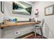Functional office nook featuring a sleek workstation, mounted TV, and stylish decor at 3870 Windhurst Dr, Lilburn, GA 30047