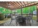 Outdoor patio with ceiling fan, comfortable seating, and views of the private backyard at 3870 Windhurst Dr, Lilburn, GA 30047