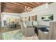 Covered back patio with ceiling fan, stylish furniture, and a view of nature at 3870 Windhurst Dr, Lilburn, GA 30047
