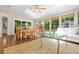 Bright sunroom with hardwood floors, a skylight, and large windows providing ample natural light at 3870 Windhurst Dr, Lilburn, GA 30047