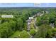Aerial view of the Kennesaw, GA, home on Jim Owens Rd NW, near other homes and surrounded by trees at 3924 Lorien Nw Way, Kennesaw, GA 30152