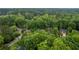 Aerial view of the home nestled among trees in a residential neighborhood at 3924 Lorien Nw Way, Kennesaw, GA 30152