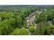 Aerial view of a residential neighborhood with houses nestled among lush green trees at 3924 Lorien Nw Way, Kennesaw, GA 30152
