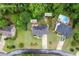 Aerial view of the home showing its location, fire pit, pool, and surrounding trees at 3924 Lorien Nw Way, Kennesaw, GA 30152