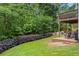 Multi-level deck and patio with lush landscaping and a privacy fence at 3924 Lorien Nw Way, Kennesaw, GA 30152