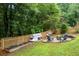 Backyard featuring a chicken coop, garden, and fire pit with Adirondack chairs at 3924 Lorien Nw Way, Kennesaw, GA 30152