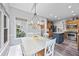 Bright eat-in kitchen featuring a white table and chairs with a view into the open-concept kitchen with stainless appliances at 3924 Lorien Nw Way, Kennesaw, GA 30152