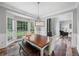 Bright dining room with large windows, stylish chandelier, and comfortable seating for Gathering gatherings at 3924 Lorien Nw Way, Kennesaw, GA 30152