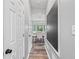 Hallway view into the dining room showcasing wainscoting, stylish light fixture and chalkboard wall at 3924 Lorien Nw Way, Kennesaw, GA 30152