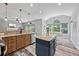 Spacious kitchen featuring granite countertops, island and stainless steel appliances, flowing to dining area at 3924 Lorien Nw Way, Kennesaw, GA 30152