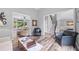 Bright living room boasts wood-look floors, comfortable seating, and a view of the outdoors at 3924 Lorien Nw Way, Kennesaw, GA 30152