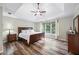 This main bedroom features a trey ceiling, ceiling fan, and many windows for lots of natural light at 3924 Lorien Nw Way, Kennesaw, GA 30152