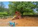 Community playground area with swings, a slide, and climbing structures on a mulch surface at 3924 Lorien Nw Way, Kennesaw, GA 30152