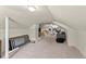 A finished attic offers versatile space, with plush carpeting and neutral tones at 1301 Eastridge Sw Rd, Atlanta, GA 30311