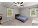 Gray bedroom featuring carpet, ceiling fan, and two windows at 1301 Eastridge Sw Rd, Atlanta, GA 30311