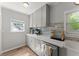 Bright kitchen features gray cabinets, stainless steel appliances, and light countertops at 1301 Eastridge Sw Rd, Atlanta, GA 30311