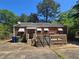 Exterior of a home with a wooden deck, minimal landscaping, and trashcans at 25 Candler Se Rd, Atlanta, GA 30317