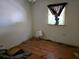 This bedroom has hardwood floors, light colored walls, and a window for natural lighting at 25 Candler Se Rd, Atlanta, GA 30317