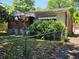Quaint single-story home with brick and white siding, lush landscaping, and a fenced front yard at 25 Candler Se Rd, Atlanta, GA 30317