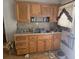 Galley kitchen features wooden cabinets, linoleum floors, and a double basin stainless sink at 25 Candler Se Rd, Atlanta, GA 30317