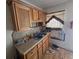 Kitchen featuring wood cabinets, laminate countertops and a stainless-steel sink at 25 Candler Se Rd, Atlanta, GA 30317