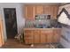 Galley kitchen features wooden cabinets, linoleum floors, and a double basin stainless sink at 25 Candler Se Rd, Atlanta, GA 30317