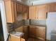 This kitchen features wooden cabinets, light countertops, and a stainless steel sink at 25 Candler Se Rd, Atlanta, GA 30317